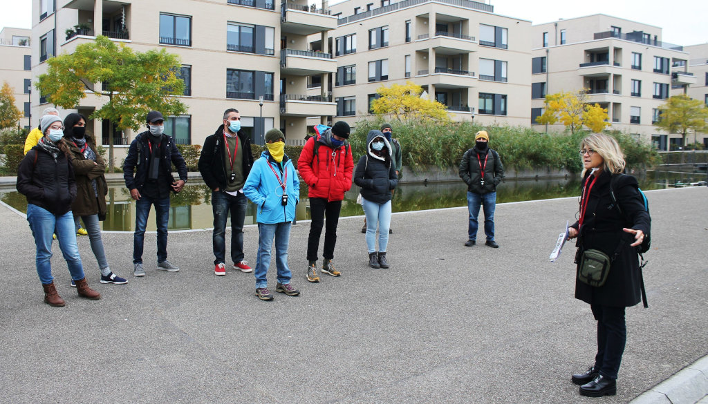 photo group of students with professor, building in the background