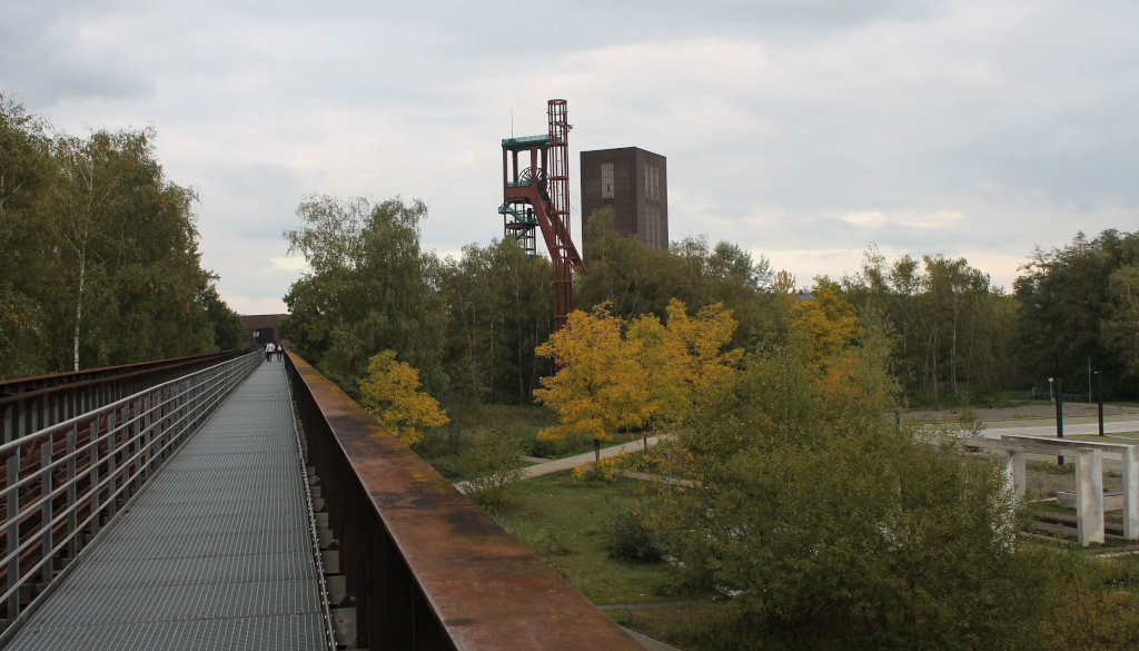 photo steel bridge, trees, meadow and steel construction in the background